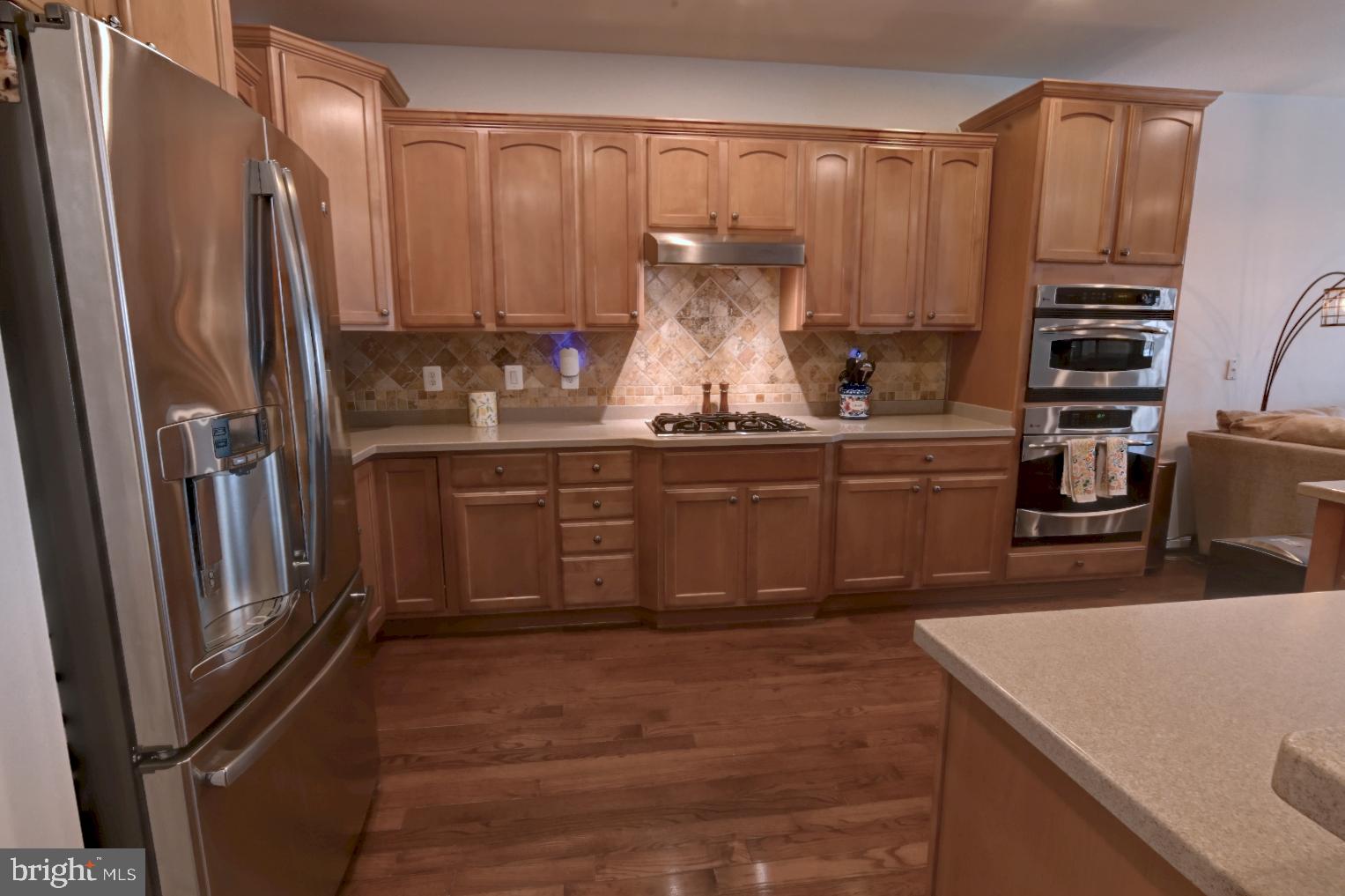 13170 Triple Crown Loop Gainesville, VA 20155 - Photo 20 of 71 a kitchen with stainless steel appliances a refrigerator and a sink