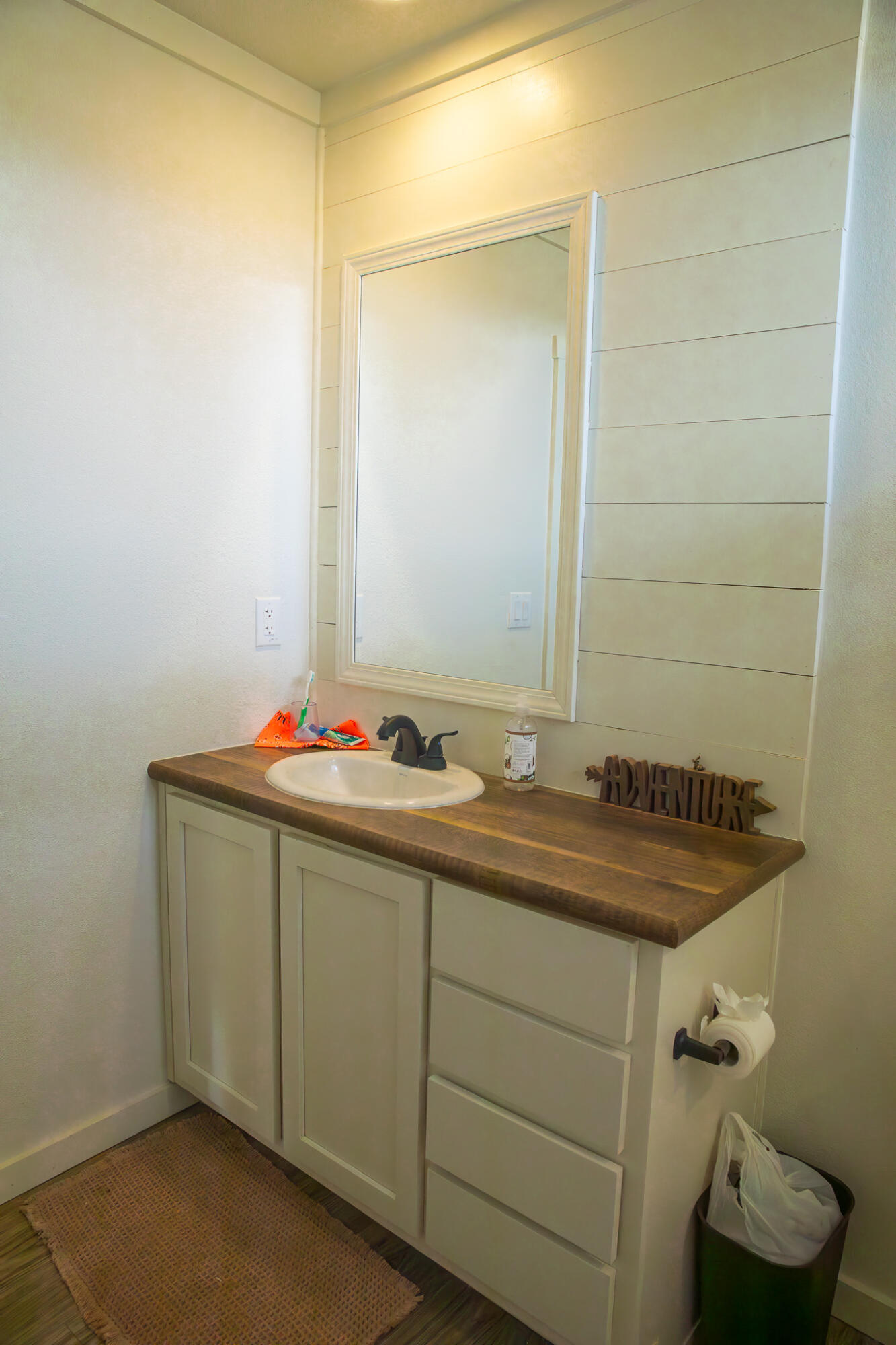 1388 Mallard Road Wilson, TX 79381 - Photo 21 of 45 a bathroom with a granite countertop sink and a mirror