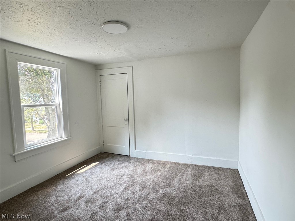 459 Patterson Avenue Akron, OH 44310 - Photo 9 of 24 2nd floor apt. Bedroom featuring carpet flooring and a textured ceiling