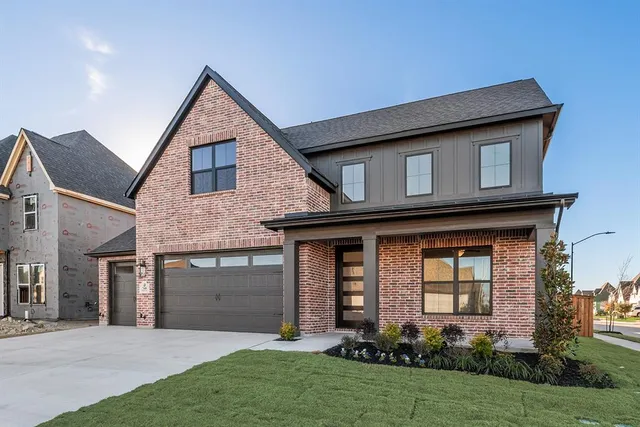 a front view of a house with a yard and porch