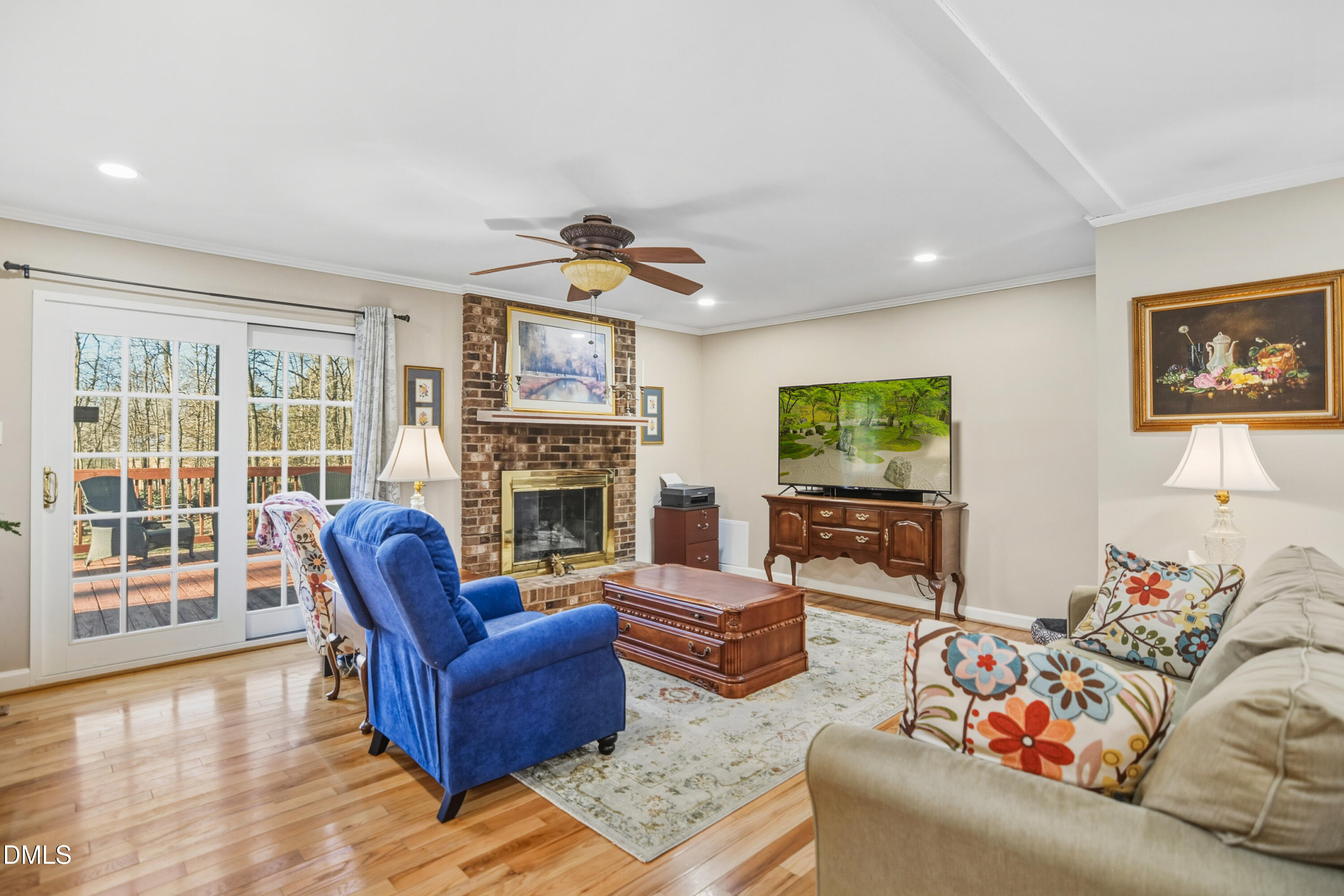 4911 Seterra Bend Durham, NC 27712 - Photo 5 of 26 a living room with furniture a fireplace and a flat screen tv