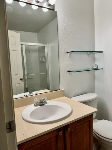 a bathroom with a glass shower door