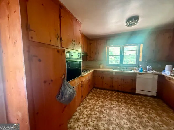 a kitchen with sink a window and stainless steel appliances