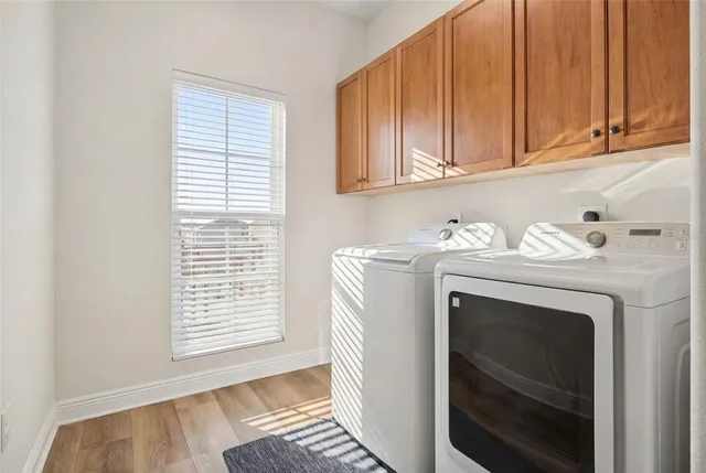 a front view of a house with garden and trees