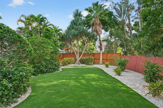 a living room with stainless steel appliances kitchen island granite countertop furniture and a wooden floor