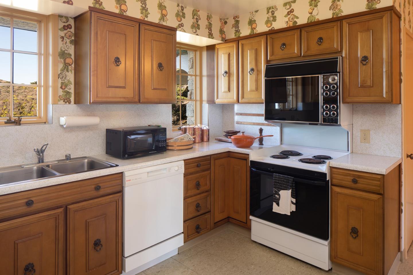 171 Spindrift Road Carmel, CA 93923 - Photo 16 of 37 a kitchen with stainless steel appliances granite countertop a stove a sink and a microwave