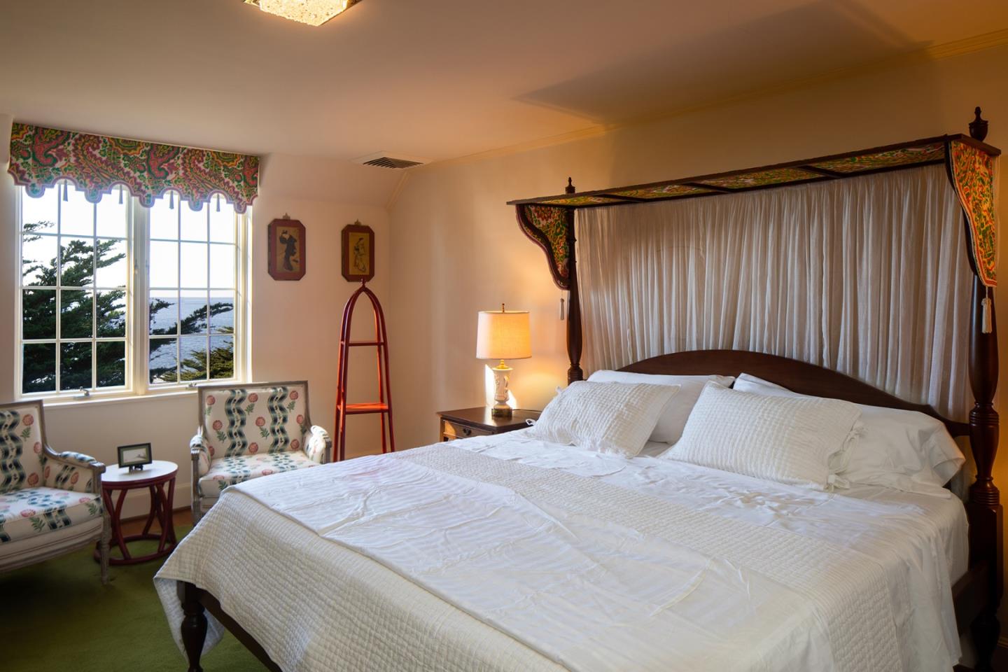 171 Spindrift Road Carmel, CA 93923 - Photo 31 of 37 a bedroom with a bed window and a large mirror