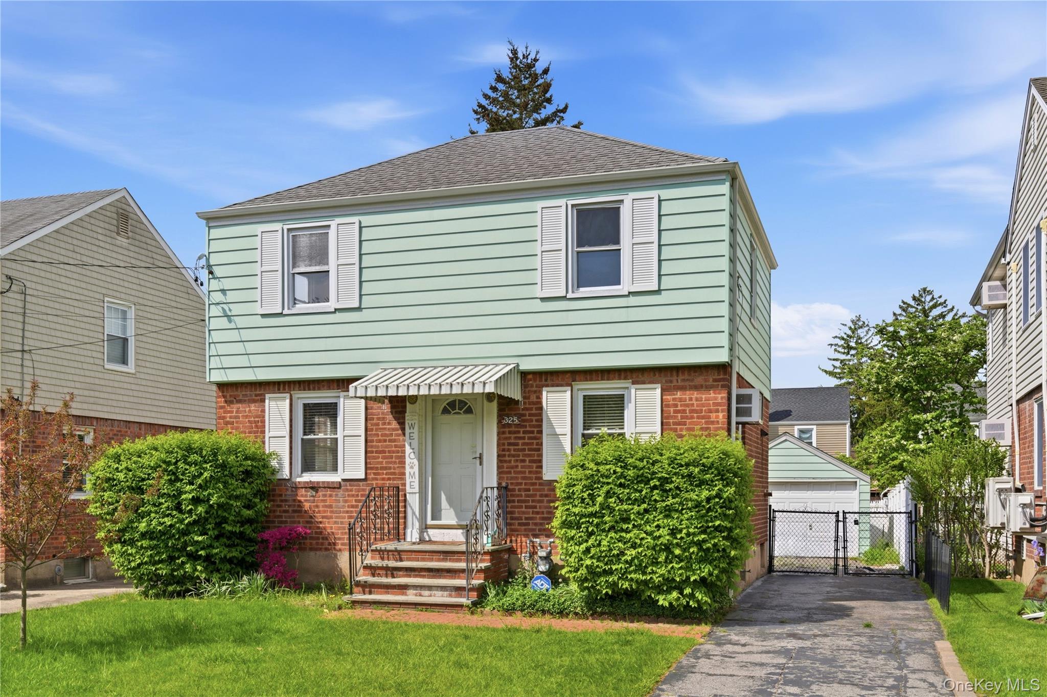 325 White Road Mineola, NY 11501 - Photo 1 of 17 a front view of a house with a yard