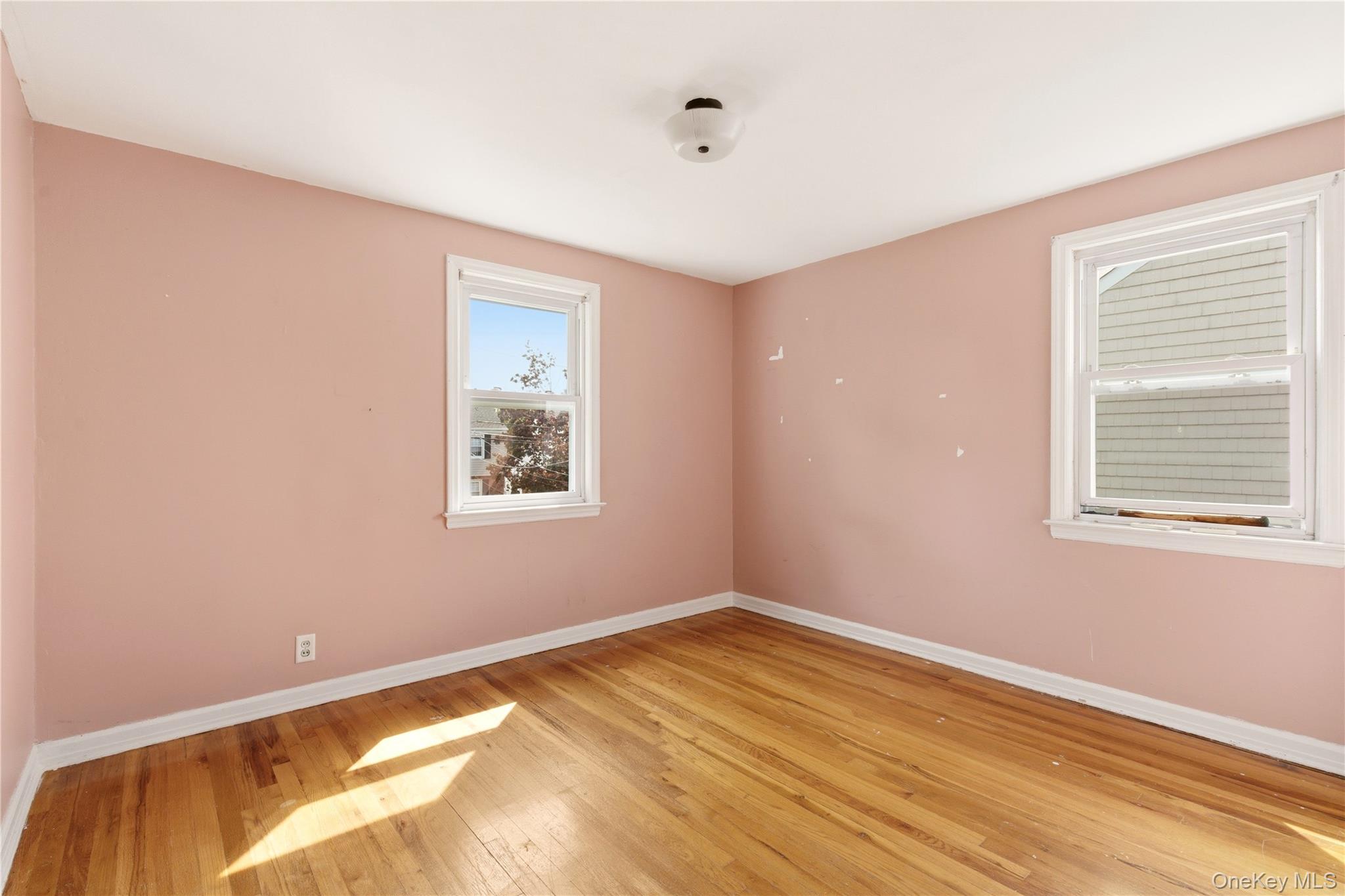 325 White Road Mineola, NY 11501 - Photo 11 of 17 a view of a room with wooden floor and windows