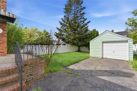 a view of a house with a small yard and wooden fence