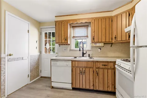 a kitchen with a sink cabinets and appliances