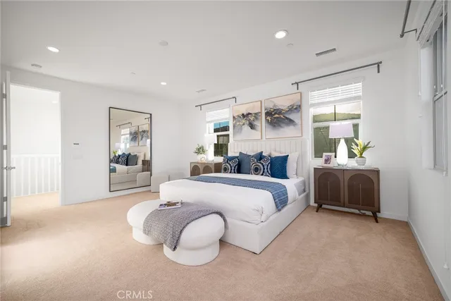 a bedroom with a bed and window