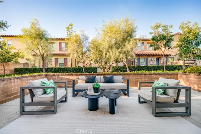 a view of a patio with couches chairs and a fire pit