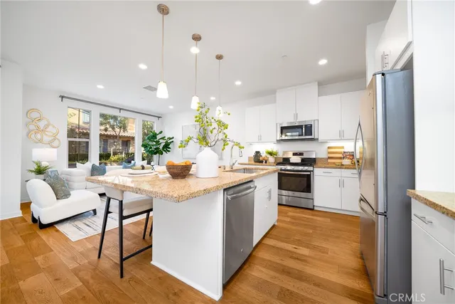 a kitchen with white cabinets and appliances