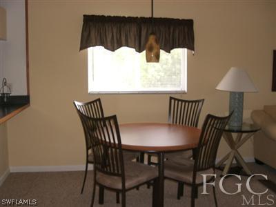 8049 Country Road, Unit 203 Fort Myers, FL 33919 - Photo 4 of 10 a view of a dining room with furniture and window