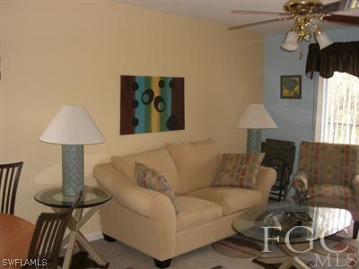 8049 Country Road, Unit 203 Fort Myers, FL 33919 - Photo 5 of 10 a living room with furniture and a lamp