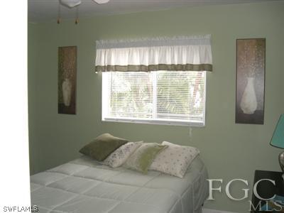 8049 Country Road, Unit 203 Fort Myers, FL 33919 - Photo 6 of 10 a bedroom with a bed and a window
