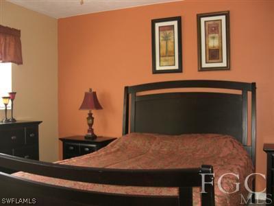8049 Country Road, Unit 203 Fort Myers, FL 33919 - Photo 7 of 10 a bedroom with a bed and a dresser