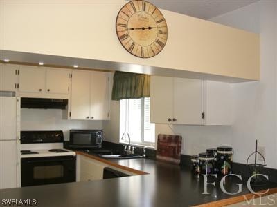 8049 Country Road, Unit 203 Fort Myers, FL 33919 - Photo 8 of 10 a kitchen with a table and chairs in it