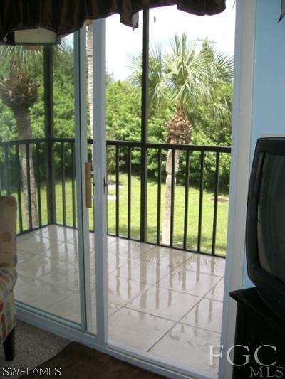 8049 Country Road, Unit 203 Fort Myers, FL 33919 - Photo 10 of 10 a view of a glass door with a balcony
