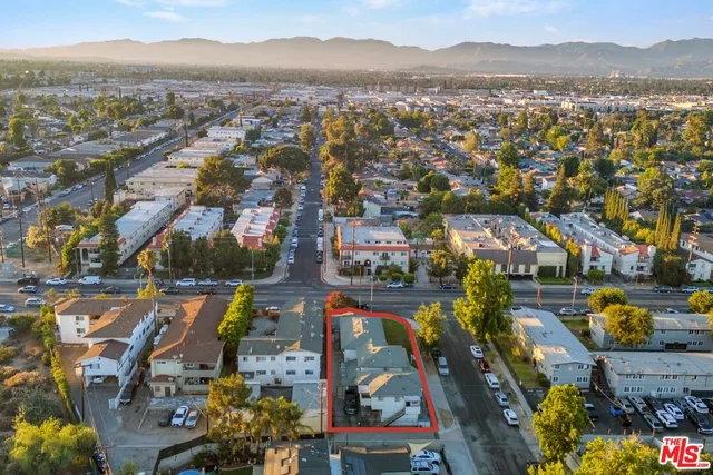 an aerial view of residential houses with outdoor space and river