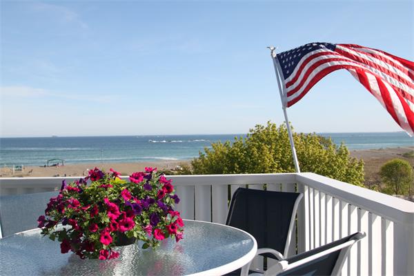 a view of a balcony with many potted plants