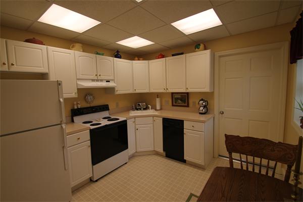 6 Gilbert Heights Road Marblehead, MA 01945 - Photo 11 of 15 a kitchen with a refrigerator a stove a sink dishwasher and white cabinets