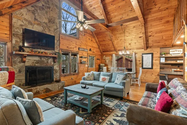 a living room with furniture a flat screen tv and a fireplace