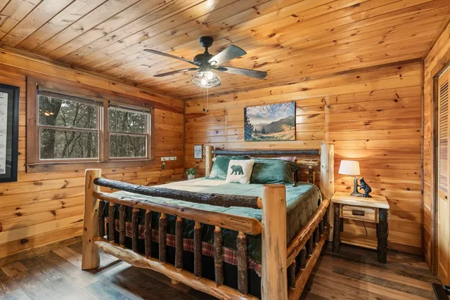 a bedroom with a bed next to a window