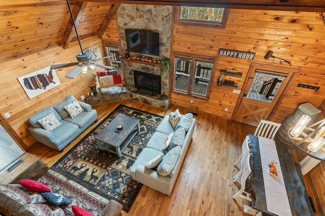 a view of a living room with furniture and a fireplace