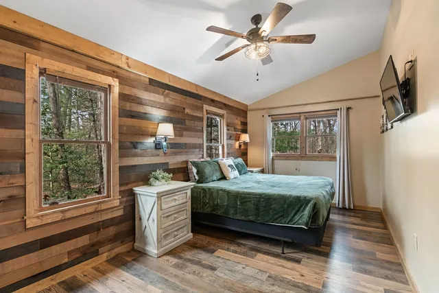 a bedroom with a large bed and a large window