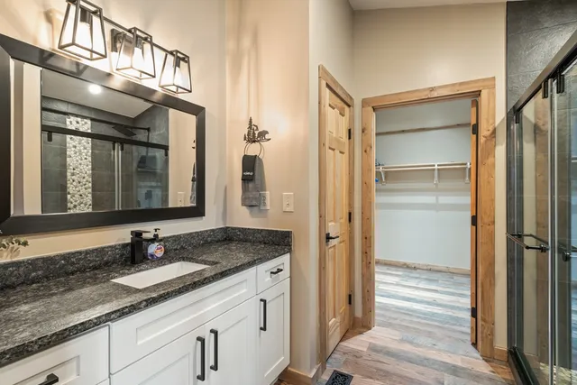 a bathroom with a granite countertop sink and a mirror