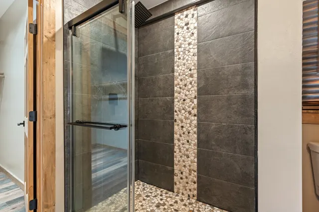 a bathroom with a glass shower door