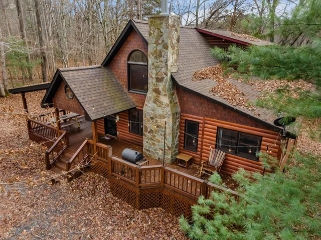 an outdoor view of house with backyard and trees
