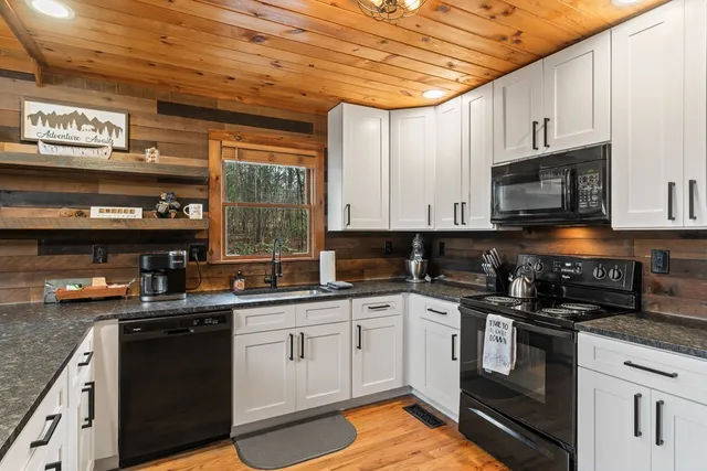 a kitchen with stainless steel appliances granite countertop a stove sink and cabinets