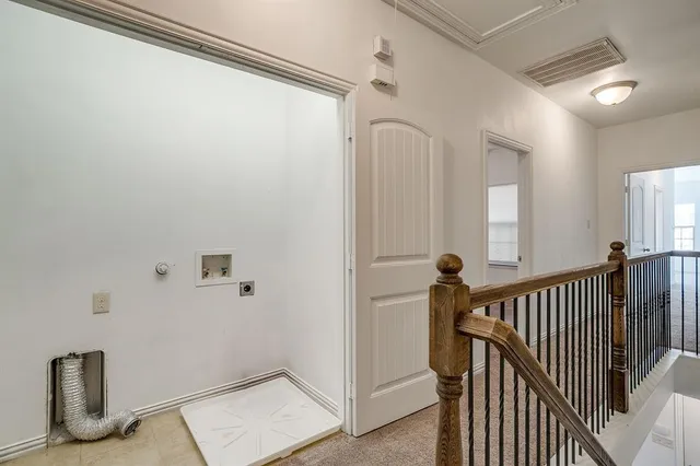 a view of hallway with stairs and a window