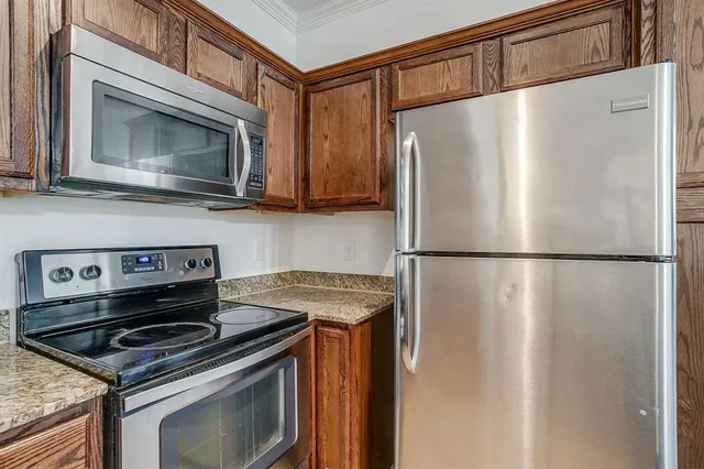 a kitchen with a stove microwave and refrigerator