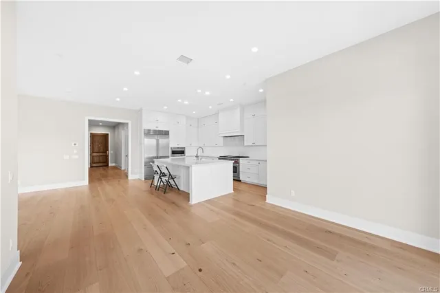 a living room with furniture and kitchen view