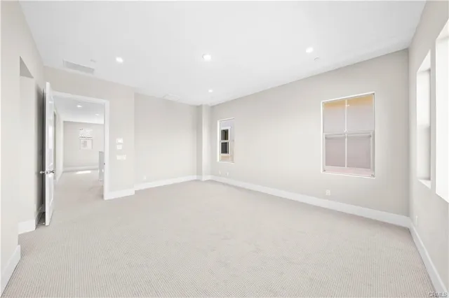 an empty room with windows and closet
