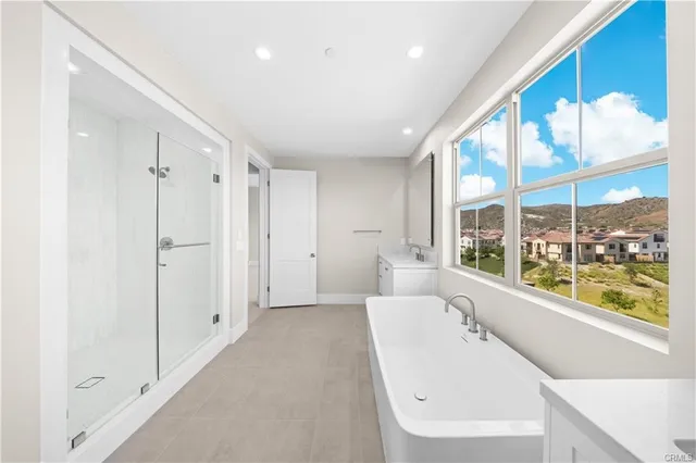 a bathroom with a tub shower and sink