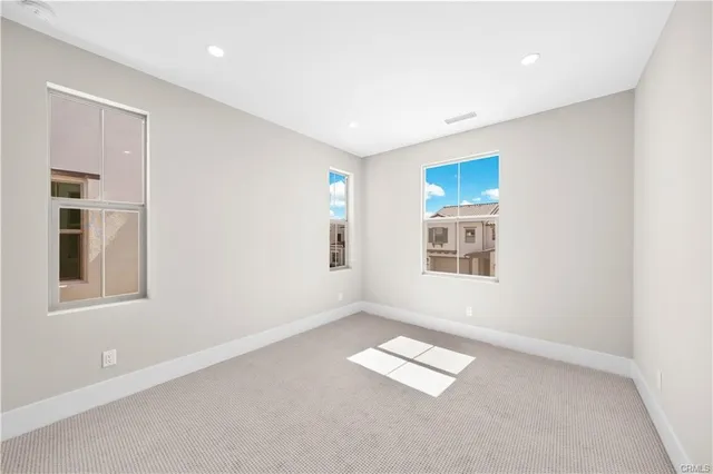 an empty room with windows and closet