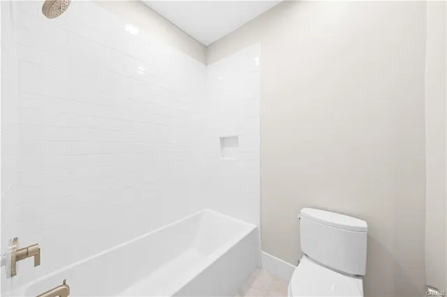 a bathroom with a toilet and bathtub