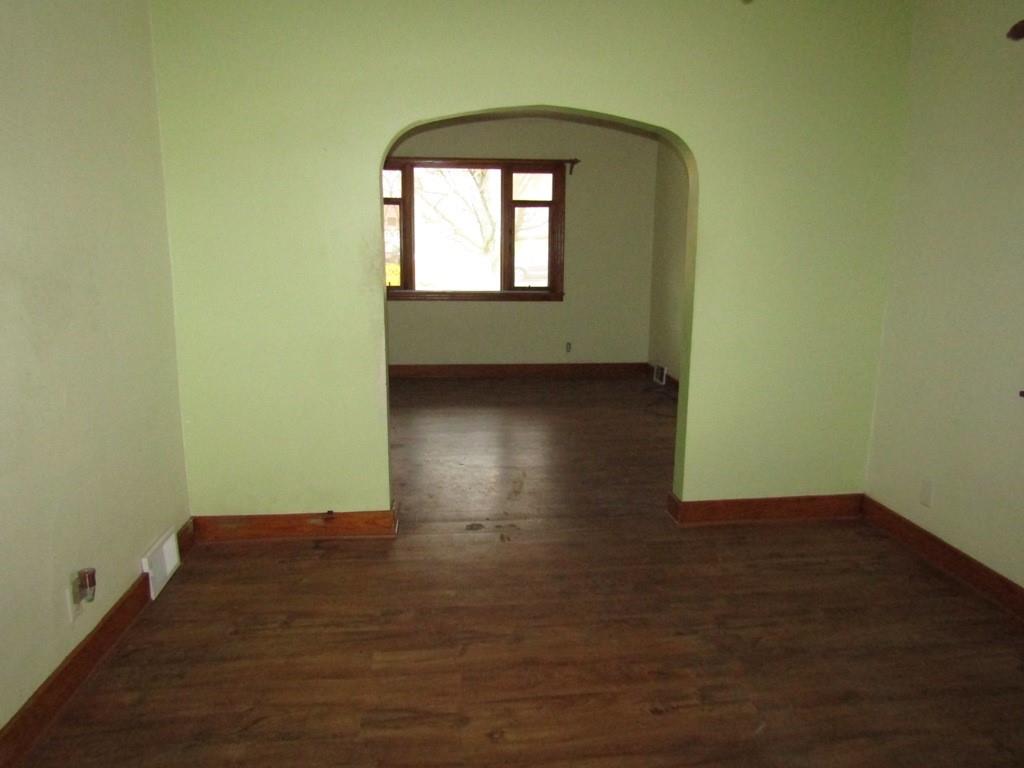 255 State Street Baden, PA 15005 - Photo 11 of 24 an empty room with wooden floor and windows