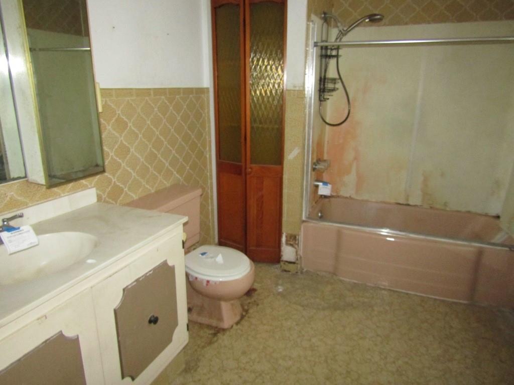 255 State Street Baden, PA 15005 - Photo 17 of 24 a bathroom with a sink a toilet and shower