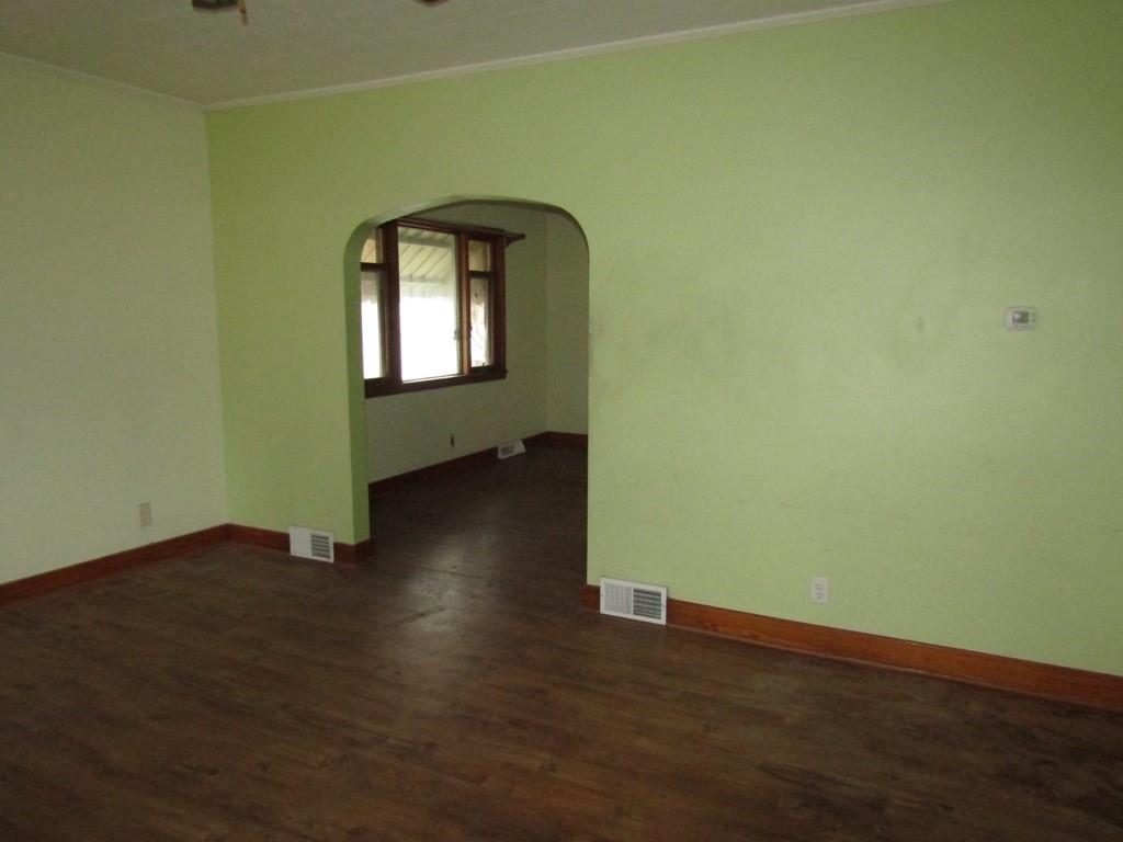 255 State Street Baden, PA 15005 - Photo 6 of 24 an empty room with wooden floor and a window