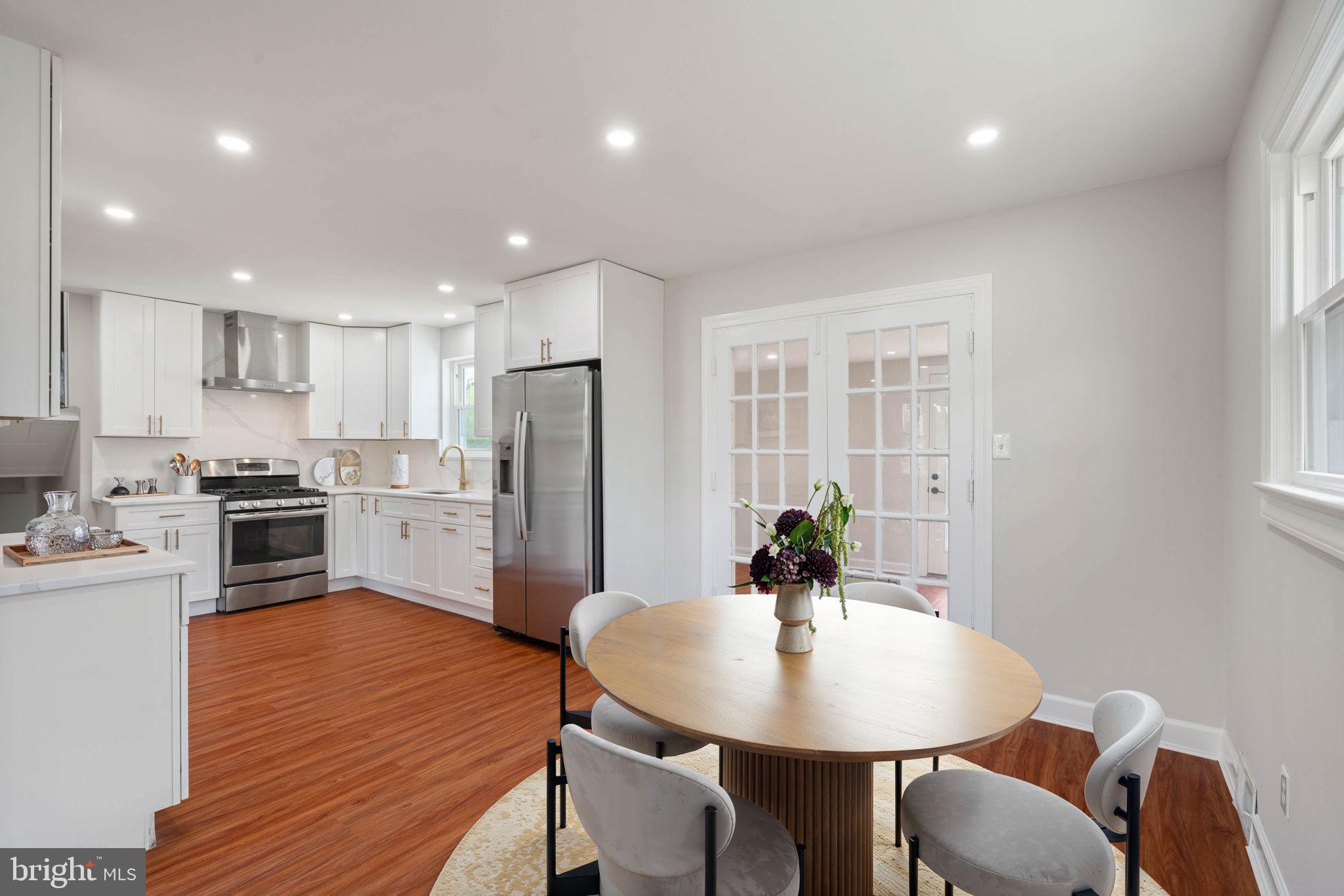 6607 Edsall Road Springfield, VA 22151 - Photo 2 of 47 a kitchen with refrigerator a sink dining table and chairs