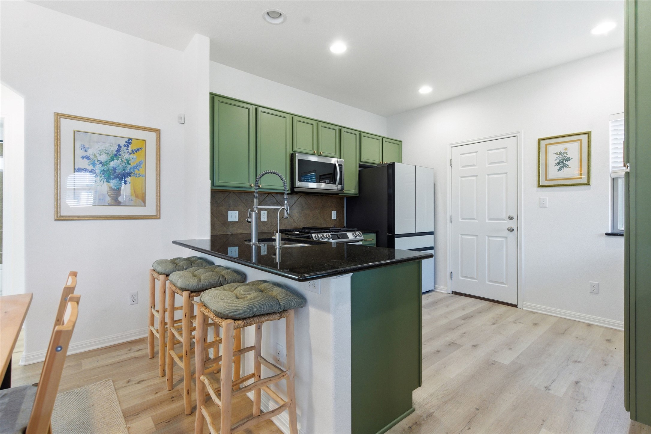 2513 Winchell Lane Austin, TX 78725 - Photo 5 of 23 a kitchen with stainless steel appliances granite countertop a stove a refrigerator a microwave a sink and a refrigerator