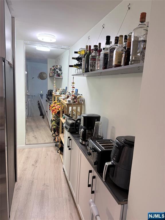 a view of a workspace with furniture and wooden floor