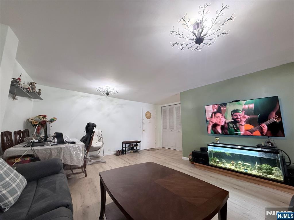 265 Main Street, Unit 113 Ridgefield Park, NJ 07660 - Photo 11 of 13 a living room with furniture and a flat screen tv