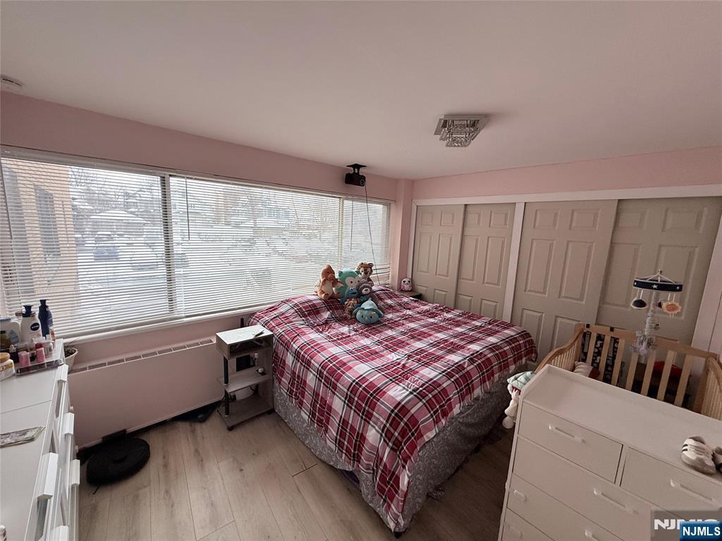 265 Main Street, Unit 113 Ridgefield Park, NJ 07660 - Photo 12 of 13 a bed room with a bed and a window